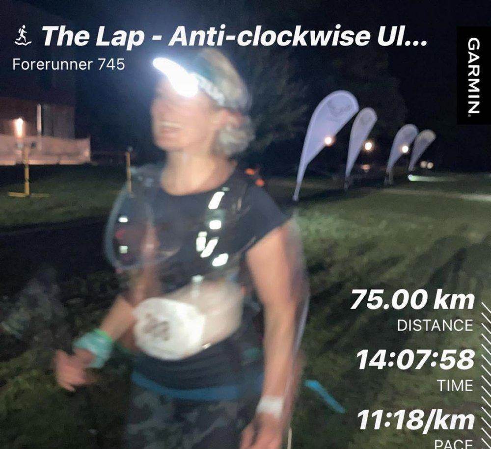 Catherine running The Lap at night with her head torch on