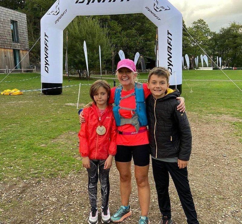 Debra with her children at The Lap finish arch