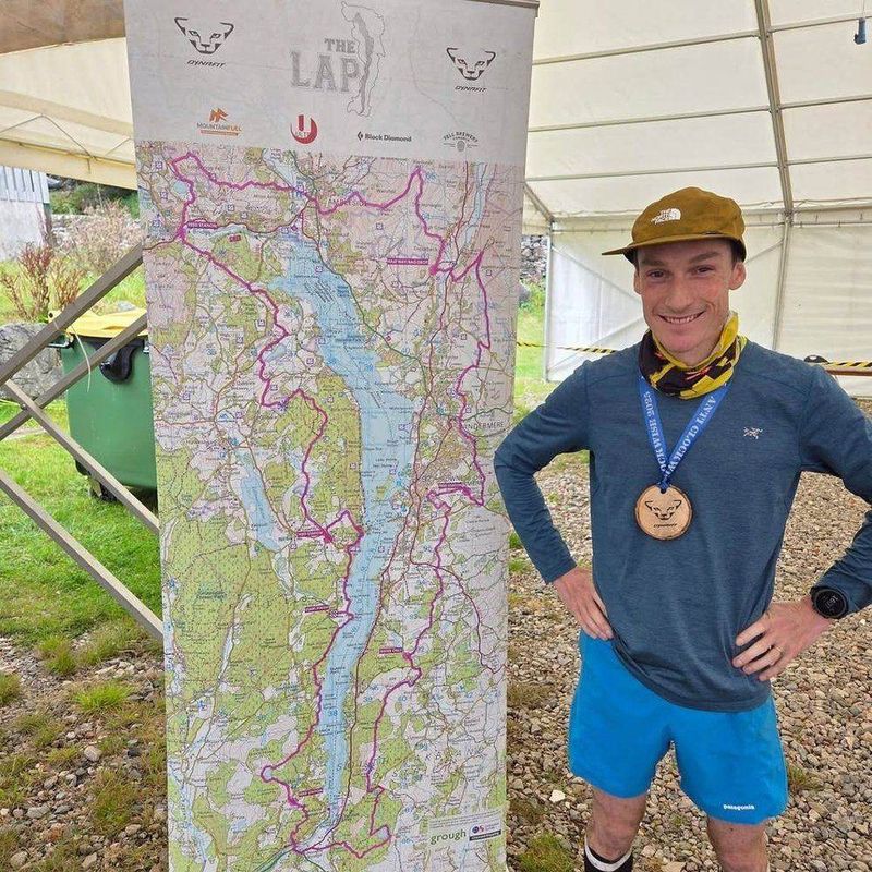 Ian with his medal in front of The Lap route map